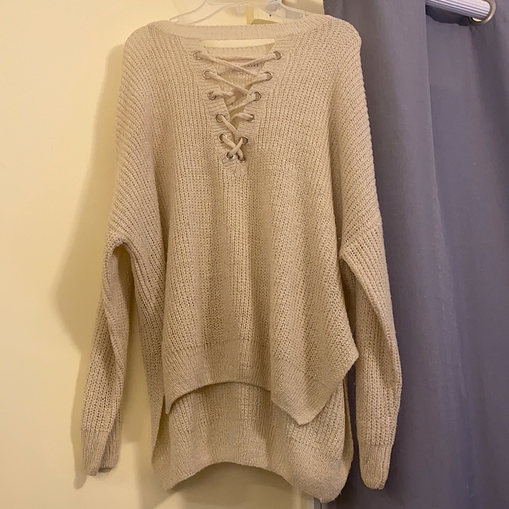 Knit sweater with criss cross design in front. Brand: Dreamers, size: M